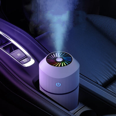 Pink columnar mini car humidifier with a power button and a clear water level indicator on a white background. - Image 11