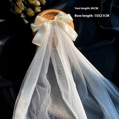 White birdcage veil with a cream satin bow and faux pearls, attached to a woven straw base, 80cm yarn length. - Image 21