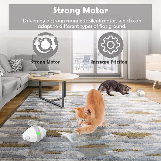 Golden-brown cat playing with a white and grey automatic rolling mouse cat toy with feather-like streamers on a wood floor. - Image 4