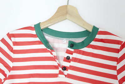 Family of six wearing matching red and white striped long-sleeved pajamas with green cuffs and festive hats. - Image 14