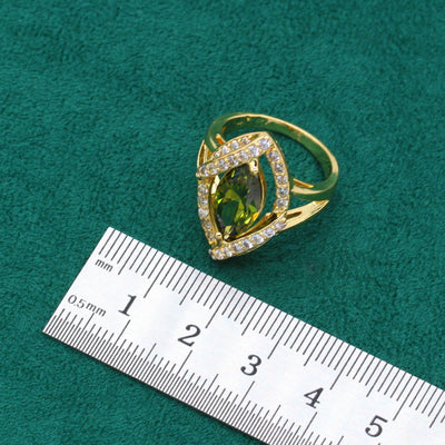 Gold-toned jewelry set with green marquise gemstones and clear accents, including a bracelet, necklace, earrings, and ring. - Image 10
