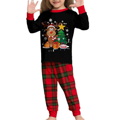Two children in black and red plaid Christmas pajamas with a reindeer and Christmas tree graphic, standing by a Christmas tree. - Image 5