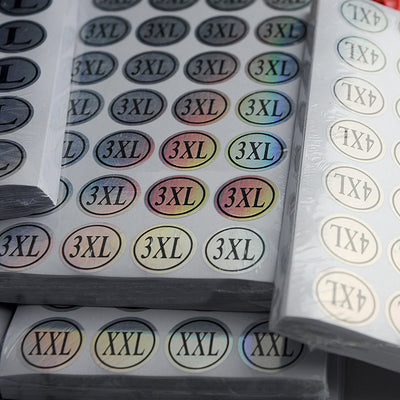 Stack of round clothing size stickers with laser color-changing background and black text, from XS to 4XL. - Image 16