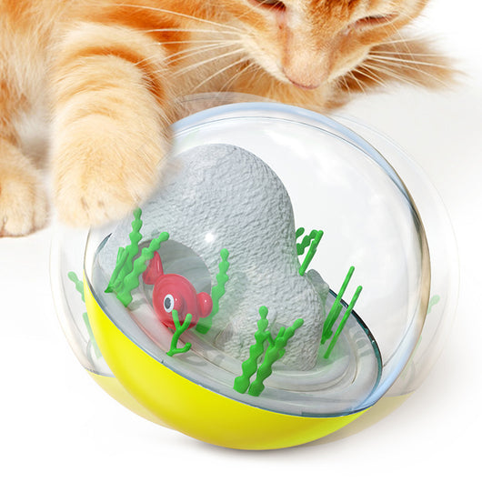 Clear and teal cat toy tumbler with a red fish and green seaweed inside, observed by a curious grey cat. - Image 7