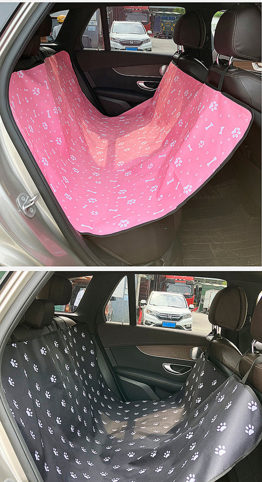 Pink car pet mat with white paw print and bone patterns, featuring black straps for securing to a rear seat. - Image 32
