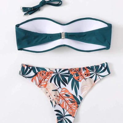 Blue bandeau bikini top with tropical leaf print high-cut bottom, styled with sandals, sunglasses, and a straw hat. - Image 4