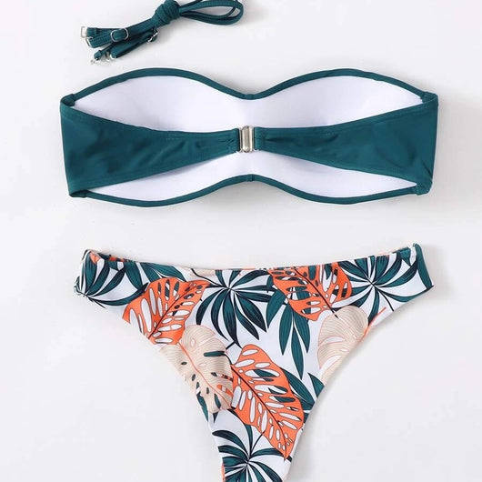 Blue bandeau bikini top with tropical leaf print high-cut bottom, styled with sandals, sunglasses, and a straw hat. - Image 4