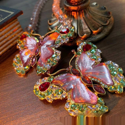 Pink enamel butterfly brooch with green, red, and clear rhinestones set in gold-toned metal. - Image 16
