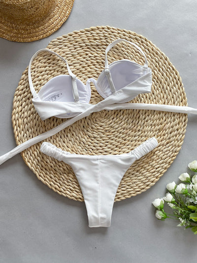 Rust underwire bikini set with ruched top and high-cut bottom, displayed on a woven mat. - Image 17