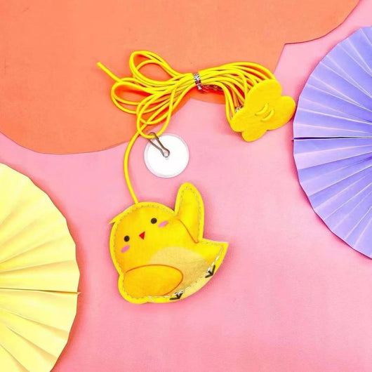 Colorful cat toy with pom-poms, googly eyes, white feathers, and a yellow elastic rope with a suction cup. - Image 9