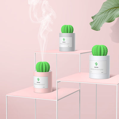 Person holding a glowing white cactus humidifier with a green top; inset shows five white humidifier filter sticks. - Image 10