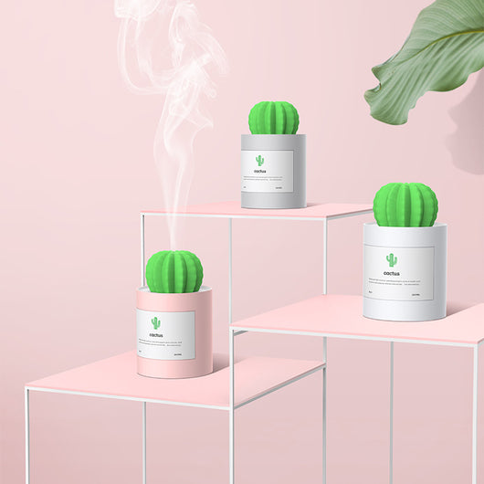 Person holding a glowing white cactus humidifier with a green top; inset shows five white humidifier filter sticks. - Image 10