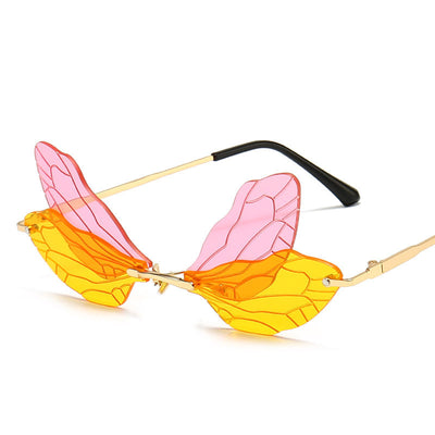 Frameless sunglasses with pink and orange-yellow dragonfly wing-shaped lenses and gold-colored metal temples. - Image 19