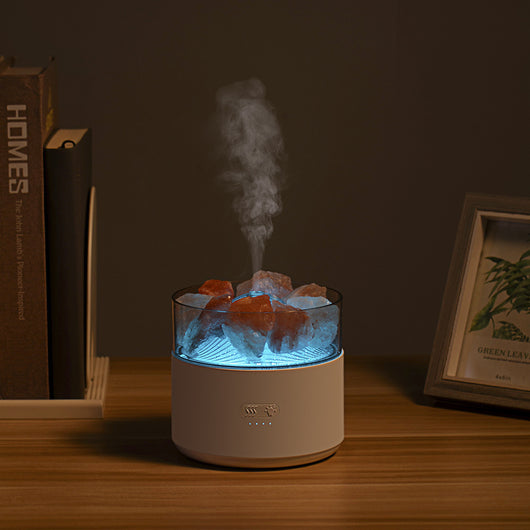 White cool-mist humidifier and aroma diffuser with glowing blue LED lights and orange crystal salt rocks, emitting mist. - Image 6