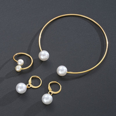 Gold-tone open cuff bracelet, matching open ring, and dangle earrings, all featuring white faux pearls. - Image 3