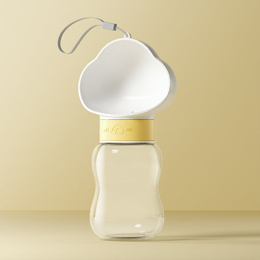 Yellow and clear portable pet water bottle with integrated drinking bowl and separate food container for walking dogs. - Image 3