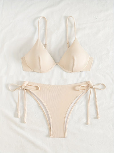 Black ribbed two-piece bikini with an underwire top and tie-side bottoms on a white marble surface. - Image 15