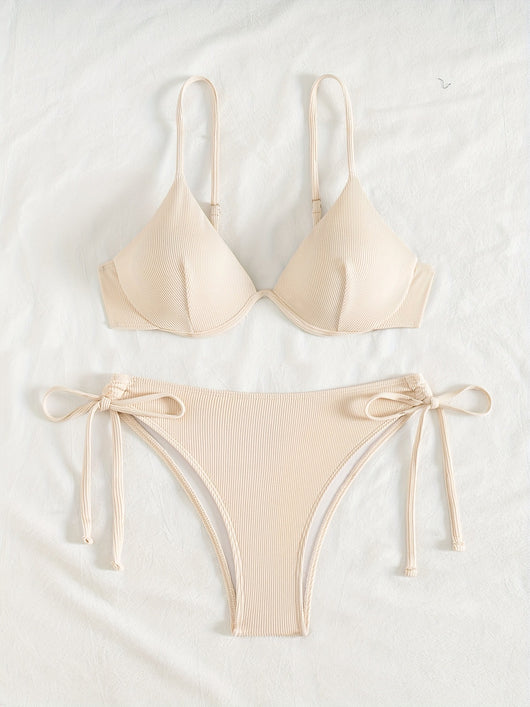 Black ribbed two-piece bikini with an underwire top and tie-side bottoms on a white marble surface. - Image 15