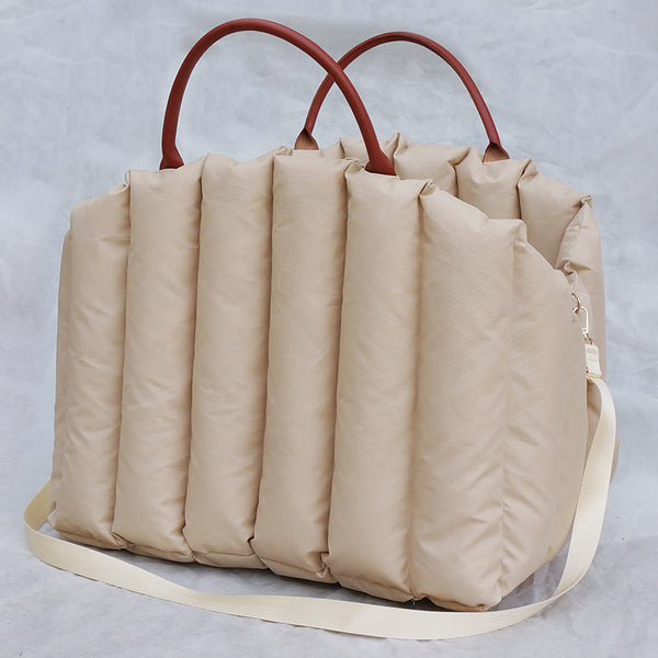 Light khaki quilted portable pet carrier with brown handles and a cream shoulder strap for car travel. - Image 6