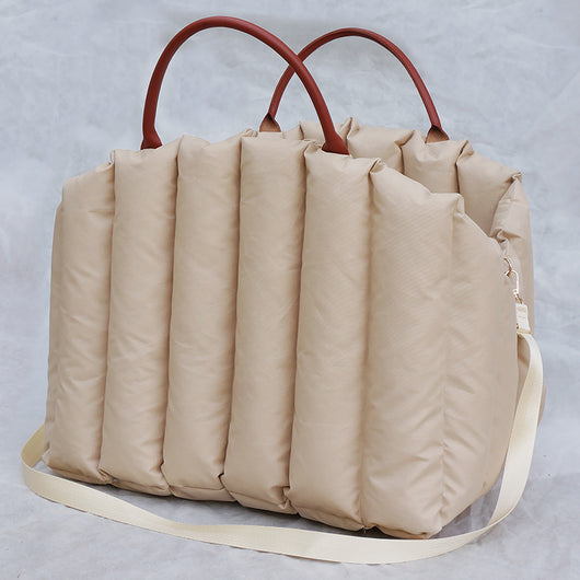 Light khaki quilted portable pet carrier with brown handles and a cream shoulder strap for car travel. - Image 6