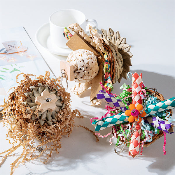 Colorful parrot bird toy with a woven basket base, braided chew sticks, crinkled paper, and a metal hanging chain. - Image 7