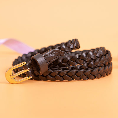 Women's braided brown leather belt with a D-shaped gold-tone pin buckle, coiled on a peach background. - Image 2