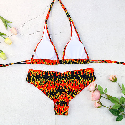 Flame print bikini swimsuit with a bandeau triangle top and tie-side split bottom in red, orange, yellow, and black. - Image 2