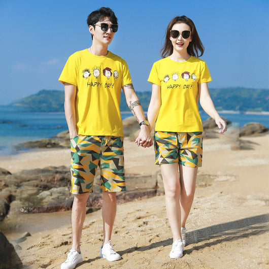 Family of four wearing matching yellow short-sleeved t-shirts with 'HAPPY DAY!' and geometric print shorts on a beach. - Image 11