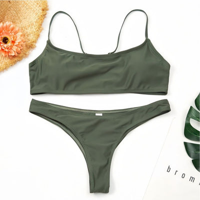Women's casual orange textured bikini set with scoop neck top and high-cut bottoms against a stone wall. - Image 4