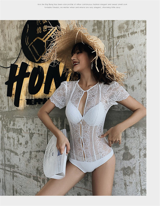 White lace cut-out one-piece swimsuit with short sleeves and a deep V-neckline, modeled by a woman. - Image 14