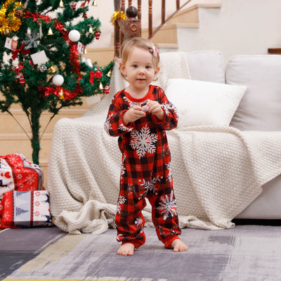 Family of five wearing matching Christmas pajamas with white 'Cousin Crew' tops and red plaid snowflake pants. - Image 9