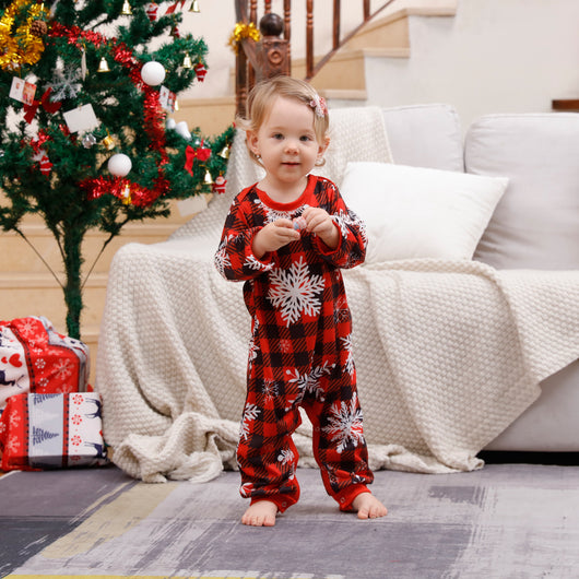 Family of five wearing matching Christmas pajamas with white 'Cousin Crew' tops and red plaid snowflake pants. - Image 9
