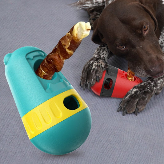 Red and black slow feeder dog toy with a treat dispenser, next to a bulldog playing with a green and yellow version.