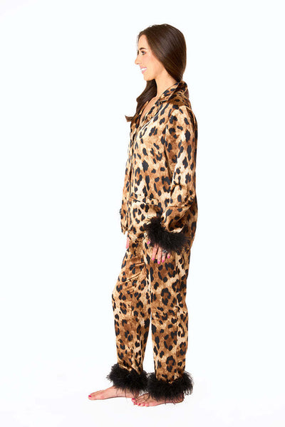 Young girl in a leopard print pajama set with black feather trim on the cuffs and ankles, wearing a pink glitter headband. - Image 13