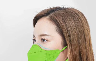 Peach disposable 3-layer face mask with perforated details worn by a person, offering comfortable daily protection. - Image 10