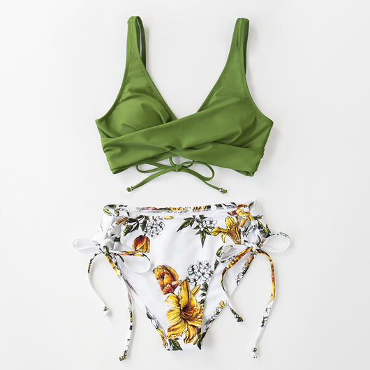 Woman in a yellow front cross lace-up bikini top and dark blue orange fruit print side-tie bottoms on a beach. - Image 11