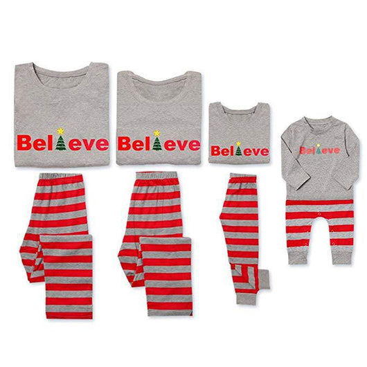Family of four in matching grey long-sleeve tops and red striped pants, posing in a festive holiday setting. - Image 6