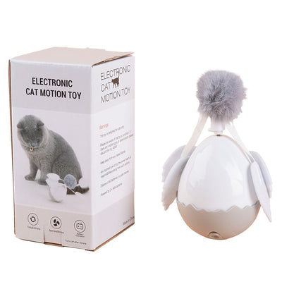 Electronic cat motion toy, a white and grey tumbler ball with fluffy pom-pom and soft wings, next to its retail box. - Image 9