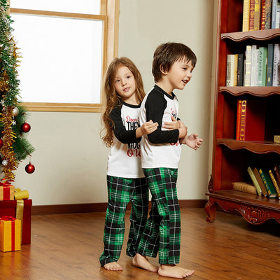 Family of four in matching Christmas pajamas with 'Dear Santa THEY'RE the NAUGHTY ones' graphic and green plaid pants. - Image 2