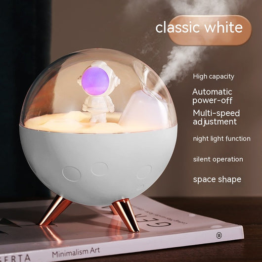 Space gray spaceman humidifier with a clear dome, glowing purple astronaut figurine, and warm yellow night light. - Image 3