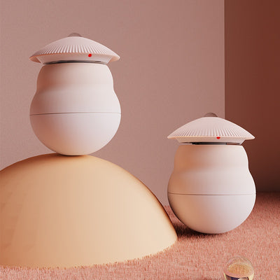 Two pink intelligent electric cat toy tumblers with ribbed tops and red laser emitters, set against a minimalist pink background. - Image 6