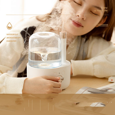 White and clear humidifier with a visible water vortex, emitting mist, and featuring a rose gold accent. - Image 9