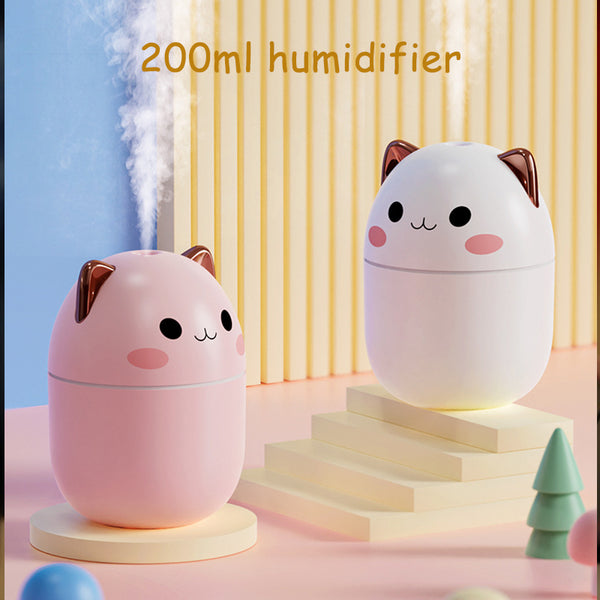 Three cute cat-shaped humidifiers in white, green, and pink, each with three filter sticks.
