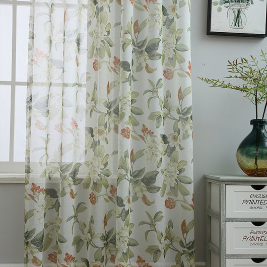 Dark gray semi-sheer curtains with a white and green floral pattern, hung on a black rod in a living room. - Image 2