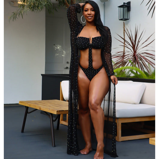 Woman in black mesh see-through long sleeve swimsuit cape over a matching cutout bandeau swimsuit with hot drilling. - Image 12