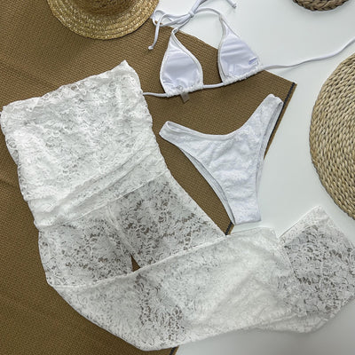 Woman wearing a white lace two-piece swimsuit set with a halter bikini top and sheer high-waisted flare pants. - Image 17