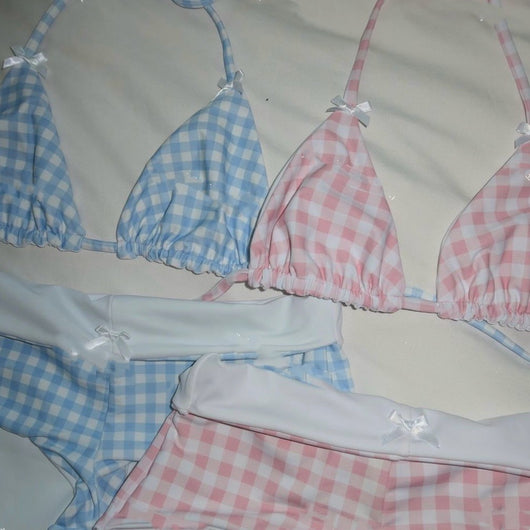 Red and white gingham high-waisted bikini set with triangle top, laid on sand under sunlight. - Image 2