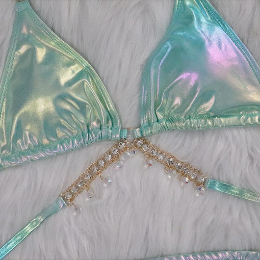 Iridescent purple and pink two-piece bikini with gold-toned crystal embellishments on a white faux fur background. - Image 14