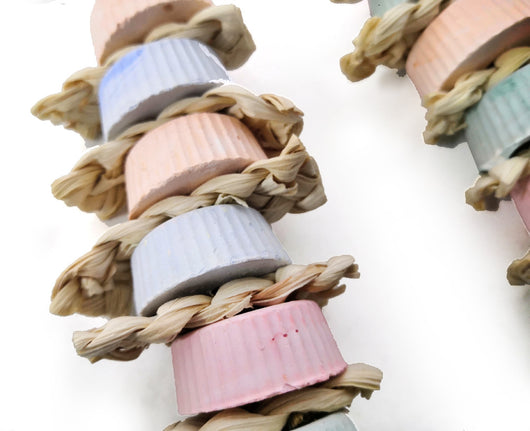 Colorful bird toy with stacked ridged blocks, natural straw, a wooden perch, and a golden bell, hanging from a metal clip. - Image 3