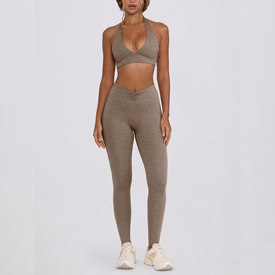 Light pink halter neck sports bra and high-waisted leggings workout set on a model. - Image 16